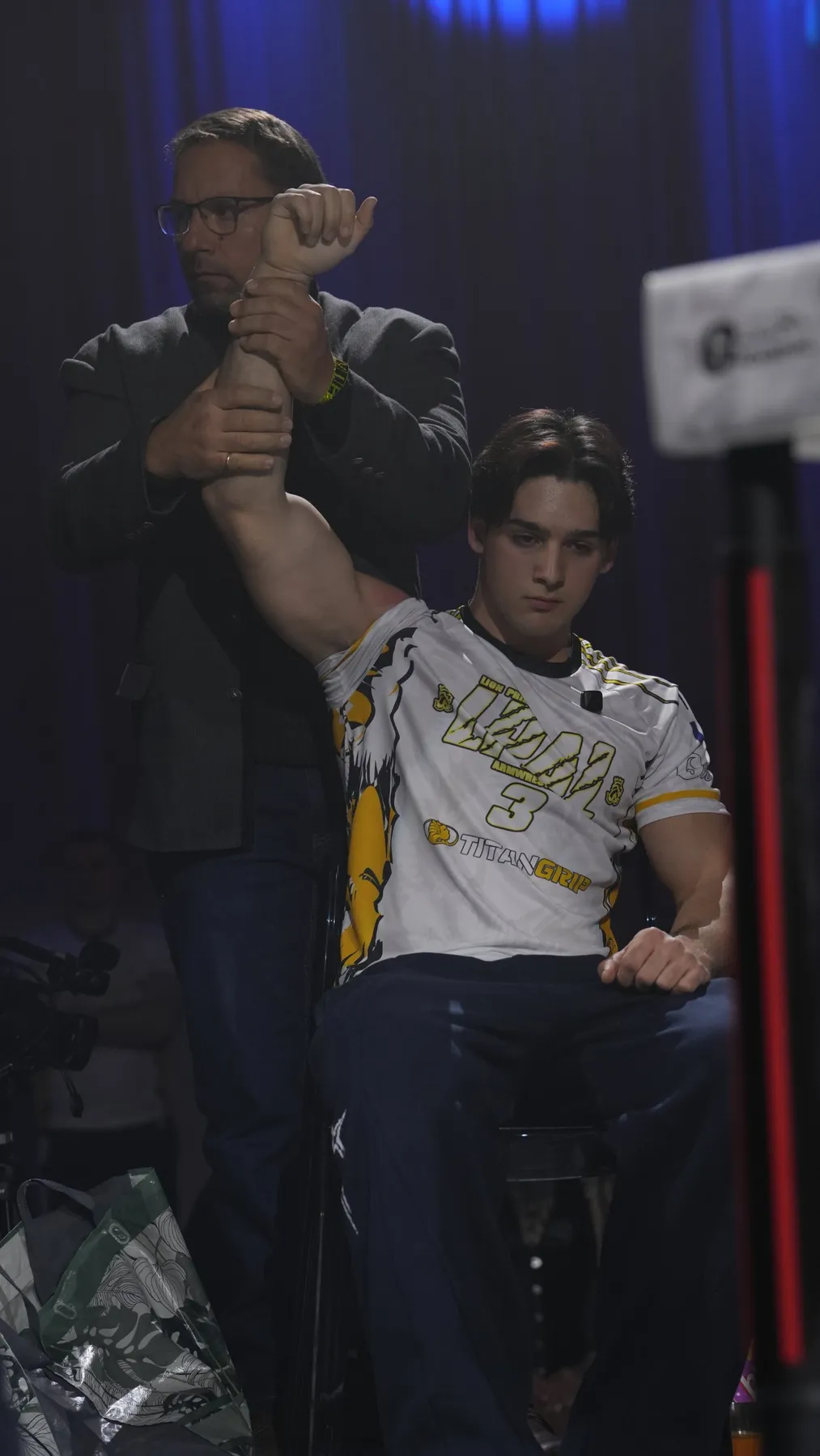 Ethan's father helping him warm up before the match