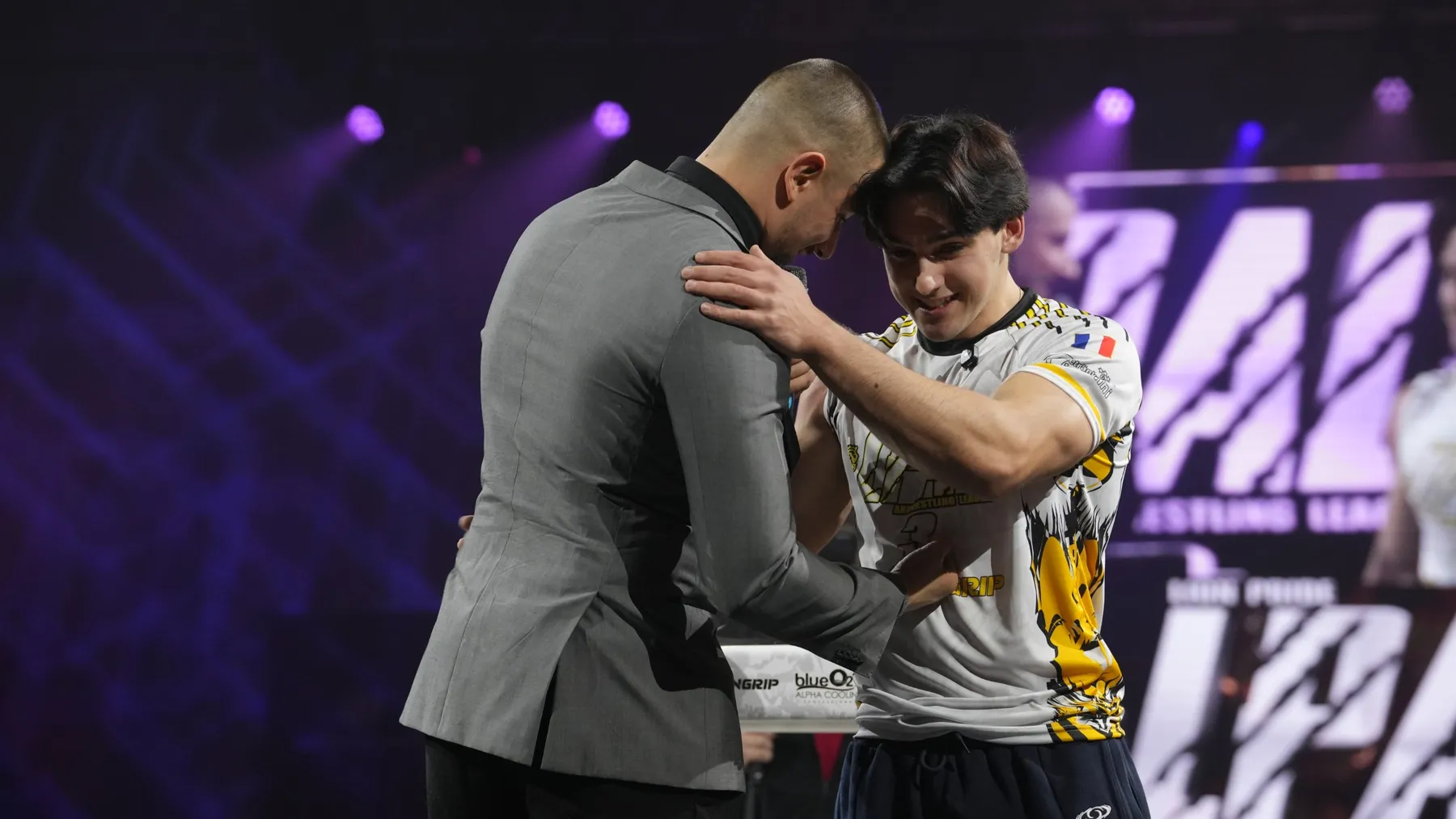 Ethan embracing the host on stage